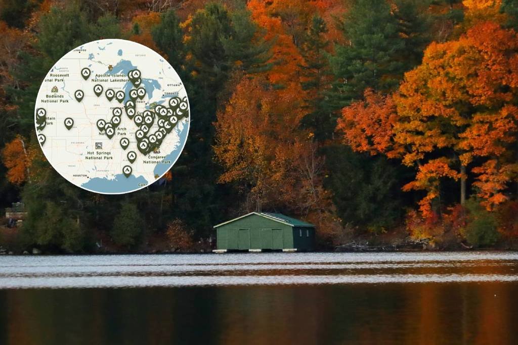 Canoeing through Adirondack Park during New York Autumn Beauty with Mid Breaker Travel Guides,Colorful fall foliage reflecting on Adirondack Lake in Upstate New York,Paddler exploring New York Autumn Beauty by canoe in the Adirondacks,Golden autumn trees surrounding calm waters in Adirondack Park,Mid Breaker Travel Guides showcasing a canoe journey through Upstate New York,Horse-drawn carriage ride to Newcomb Lake in the Adirondacks,Morning mist rising over Adirondack Lake during New York Autumn Beauty,Traveler camping beside a peaceful lake in the Adirondack backcountry,Sunset reflecting on tranquil Adirondack waters with fall foliage