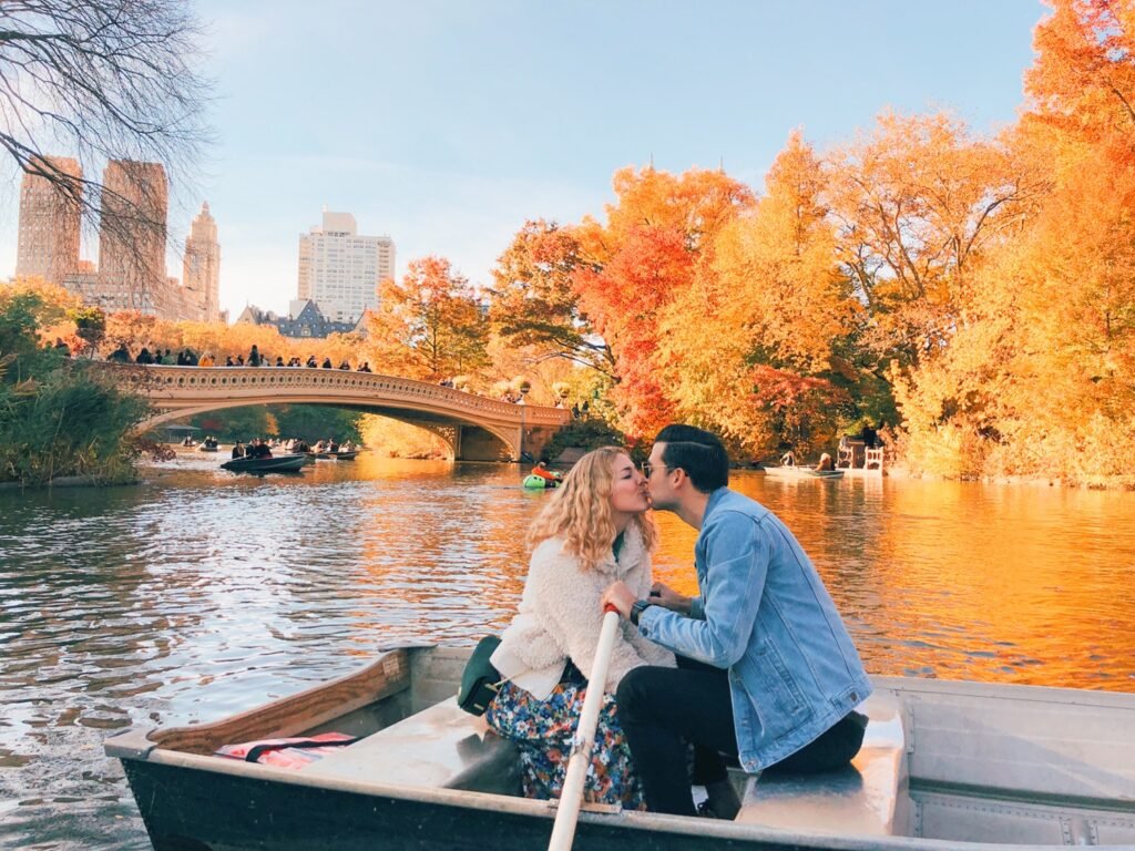 Canoeing through Adirondack Park during New York Autumn Beauty with Mid Breaker Travel Guides,Colorful fall foliage reflecting on Adirondack Lake in Upstate New York,Paddler exploring New York Autumn Beauty by canoe in the Adirondacks,Golden autumn trees surrounding calm waters in Adirondack Park,Mid Breaker Travel Guides showcasing a canoe journey through Upstate New York,Horse-drawn carriage ride to Newcomb Lake in the Adirondacks,Morning mist rising over Adirondack Lake during New York Autumn Beauty,Traveler camping beside a peaceful lake in the Adirondack backcountry,Sunset reflecting on tranquil Adirondack waters with fall foliage